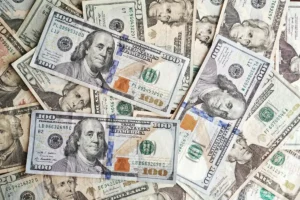 Unsure where to put your extra cash? Ask an advisor - US dollar banknotes pile