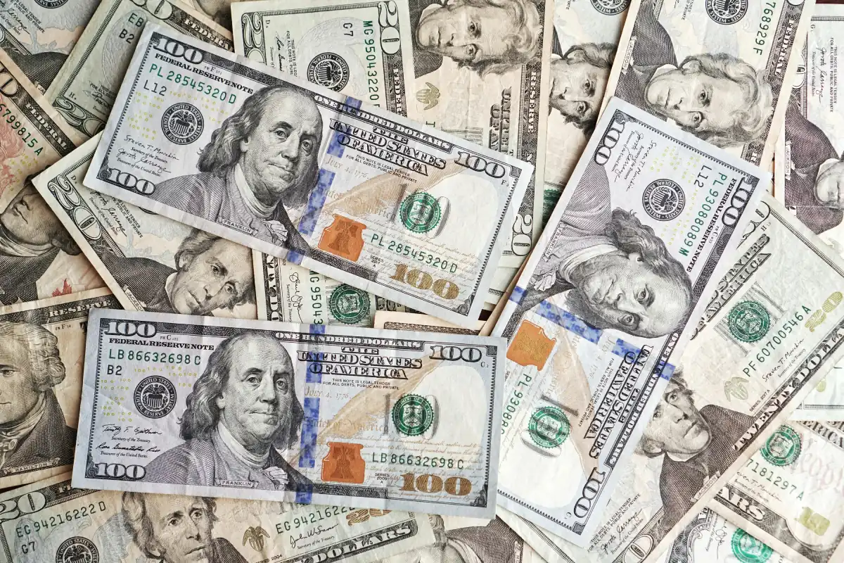 Unsure where to put your extra cash? Ask an advisor - US dollar banknotes pile