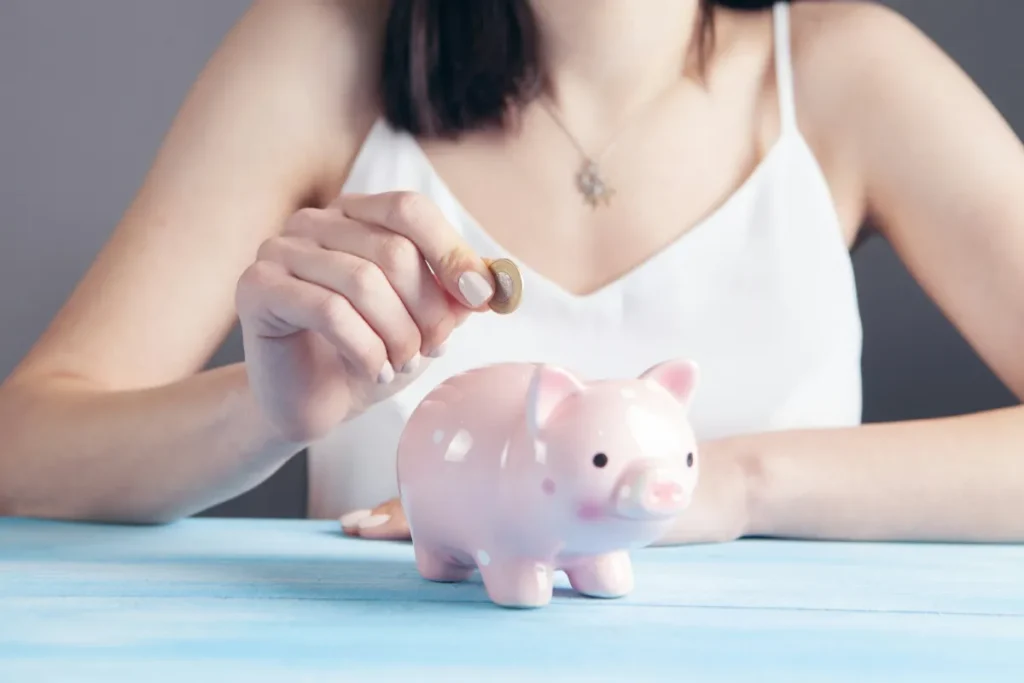 The three drivers of smart investing: discipline, luck, and seizing opportunities - woman holding pink pig figurine