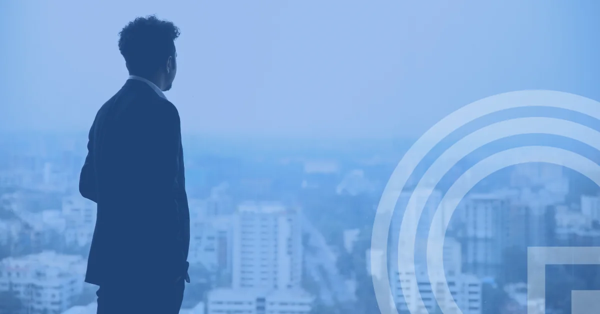 Q2 2026 market update - man in black suit standing on top of building looking at city buildings