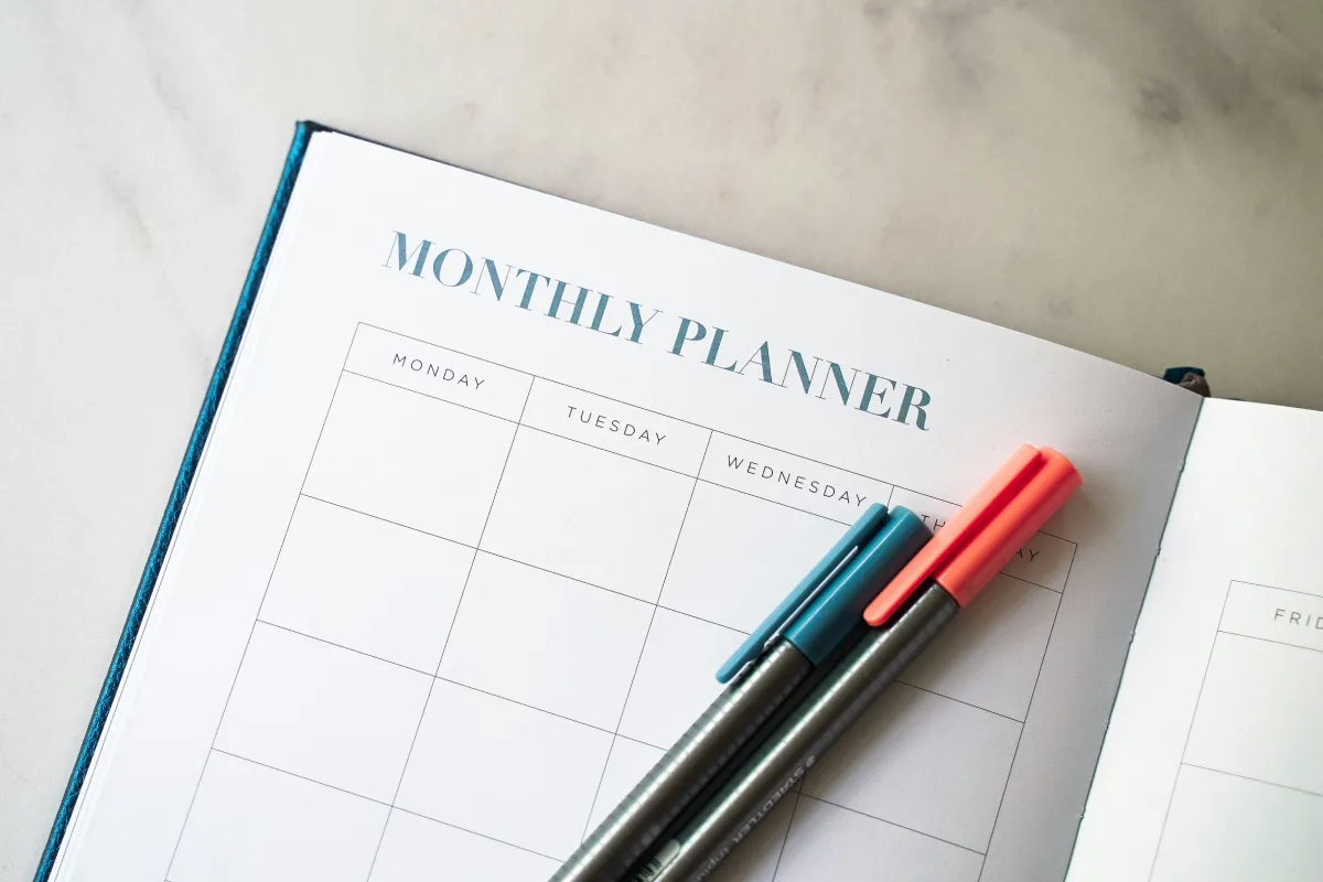 When life gets hard, preparation makes the difference blog header - a planner with two pens