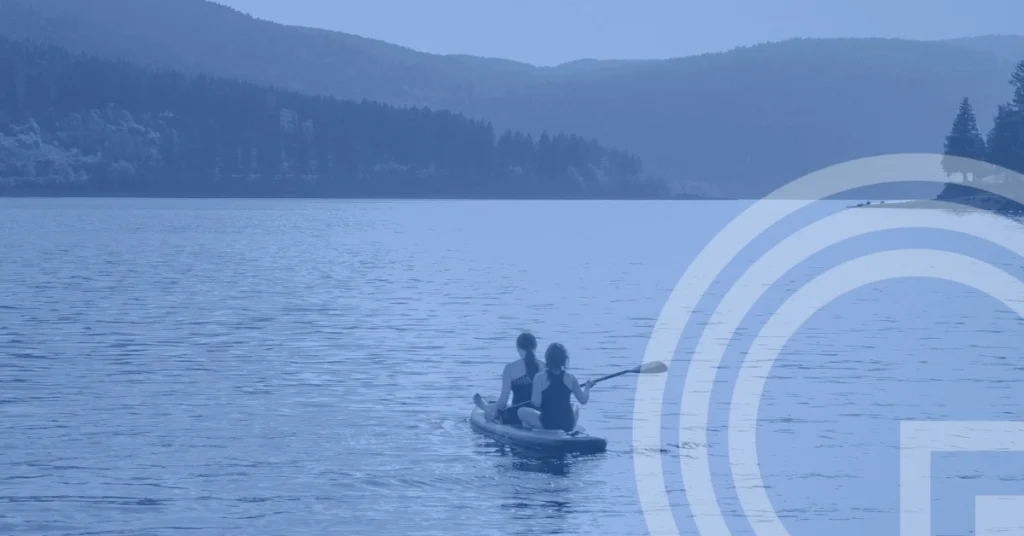 Q3 2026 market review - two people kayaking on a tranquil lake
