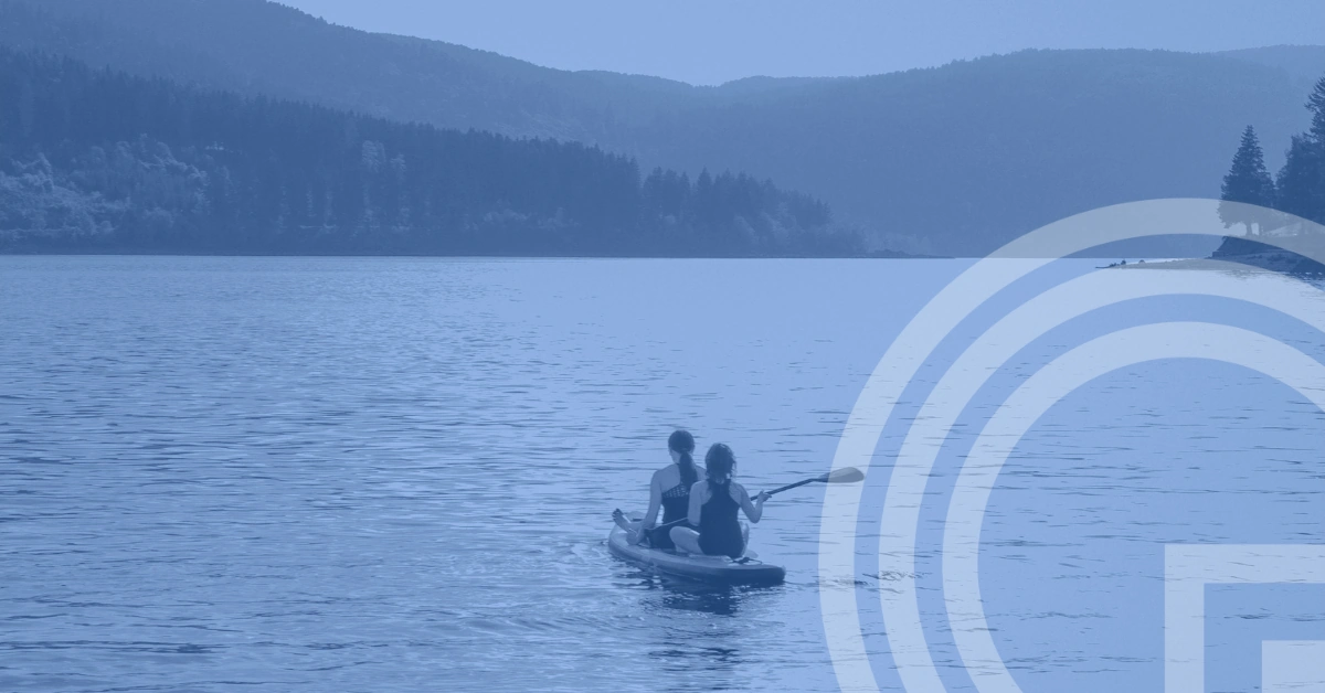 Q3 2026 market review - two people kayaking on a tranquil lake